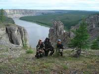 The view to the east as Paul Montesano, Jon, Ranson, and Guoqing Sun take a knee on the cliffs overlooking the confluence of the Kotuykan and Kotuy Rivers