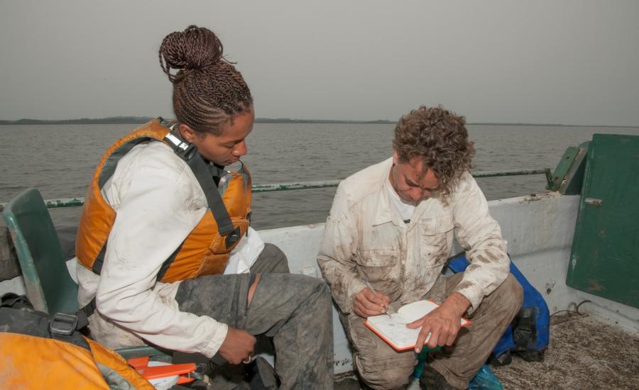 Lola Fatoyinbo and Marc Simard entering data after mangrove field work in Pongara National Park. The AfriSAR mangrove team collected field measurements of forest canopy height and installed tidal gages to compare the measurements taken from LVIS and UAVSAR to measurements on the ground.