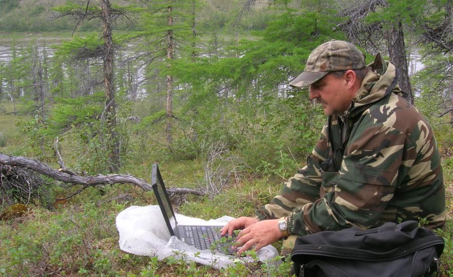 Jon Ranson working on an expedition blog post along the Kotuykan River in northern Siberia, July 2008.